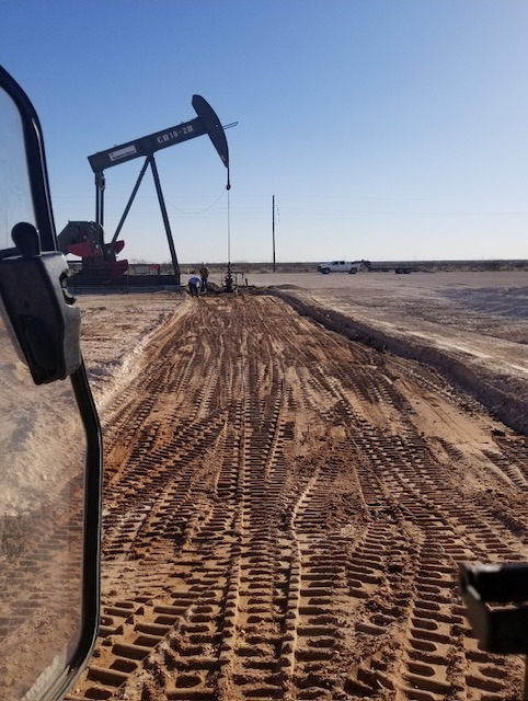 Oilfield Pump Jack Operating in a Cleared Dirt Site